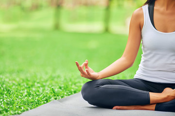 Fototapeta premium Pleasant nice woman enjoying yoga in the park