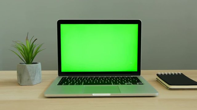 Close Up Shot Of Laptop With Green Screen On The Table. Chroma Key.