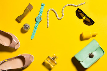 Still life of fashion woman, objects on yellow
