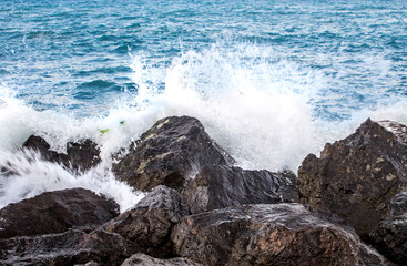 Sea waves in sunset with rocks and stones. Nature landscape.