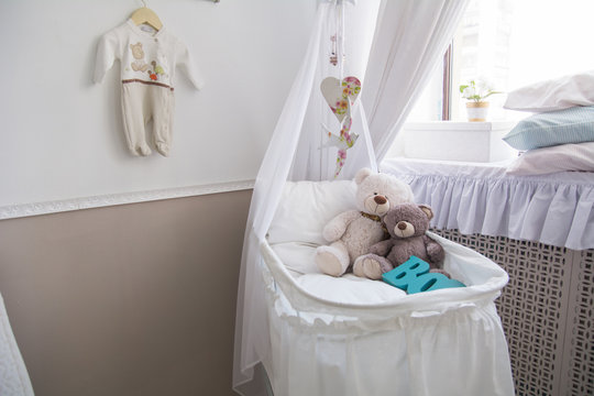 Baby cot with teddy bears in the room