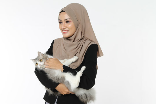 Portrait of Successful Confidence Muslim Business woman executive playing with cat isolated white background
