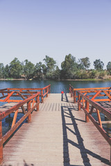 wooden pier on big lake surrounded by trees