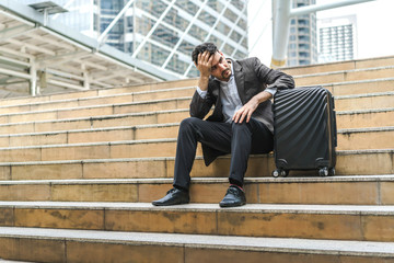 Unemployed businessman stress sitting on stair, concept of business failure and unemployment problem, work life balance.