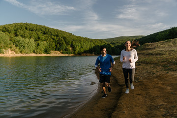 Fototapeta na wymiar Fitness workout teammates jogging in nature