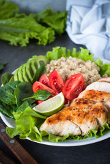 Fresh salad from quinoa, chicken breast, spinach, lettuce and tomatoes