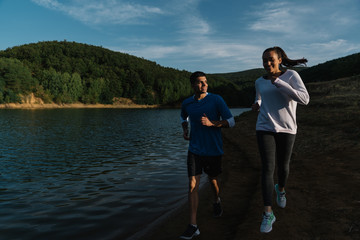 Fototapeta premium Young happy couple training to be fit together