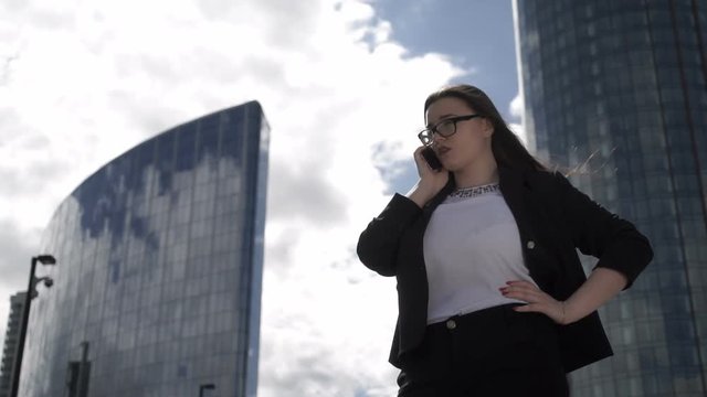 Confident woman talking phone in downtown
