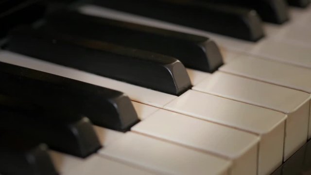 Closeup on piano keys.  Camera travel from left to right.