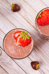 Milkshake with chocolate and strawberries. Chocolate strawberry smoothie. View from above, top studio shot