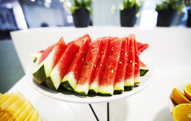 Slice of fresh red watermelon on white dish