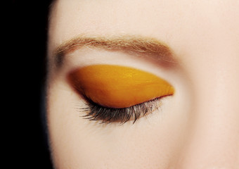a closed eye of a young woman