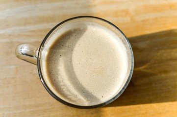 A cup of coffee  in glass cup on wooden background in Canada