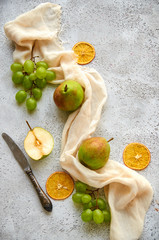 Three pears with green grapes and three dried pieces of orange decorated with silver vintage knife...