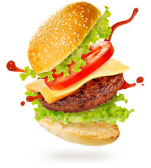 layers of cheeseburger floating on white background