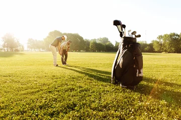 Foto auf Acrylglas Senior male coach teaching young sportsman how to play golf © Drobot Dean