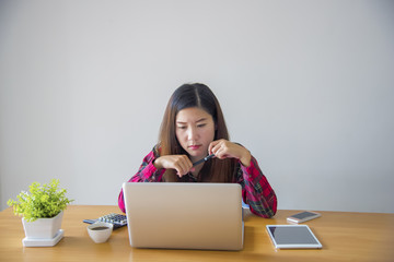 Businesswoman looking at turnover on a desk.