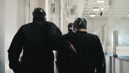 ice hockey players, team friends go to bench to start game, cold arena, power athlete hockey player go to arena from dressing room