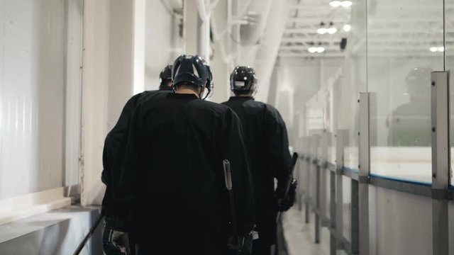 Players can not wait to go on the ice. Hockey professional team go to arena, nervous serious athletes