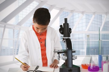 Composite image of schoolboy writing on note pad