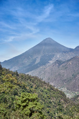Fototapeta na wymiar Santa María Volcano behind a valley / This is a large active volcano in the western highlands of Guatemala next to the city of Quetzaltenango