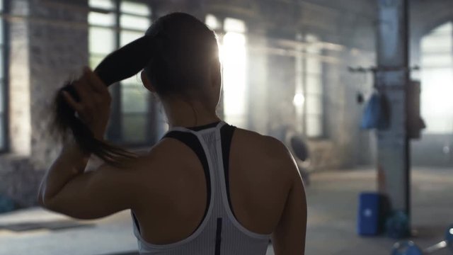 Follow-up Shot of Athletic Beautiful Woman Entering Gym in Slow Motion. She's Confident and Pulls Her Ponytail.