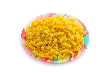 Plate of fusilli macaroni.
Closeup of a plate of raw fusilli macaroni on white background.