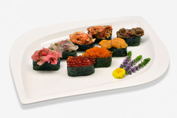 Mixed nigiri sushi (Uni(sea urchin), Ikura (salmon roe), Tobiko (flying fish roe), Otoro,Shutoro, salmon) in white plat on white background