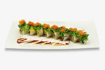 Maki roll on top with wakame and shrimp roe in white plate on white background
