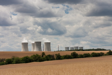 Fototapeta na wymiar Aerial view of nuclear power station with cooling towers against cloudy sky
