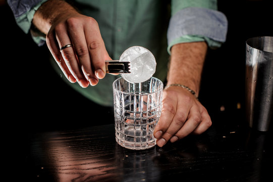 bartending concept hand cut ice ball at bar
