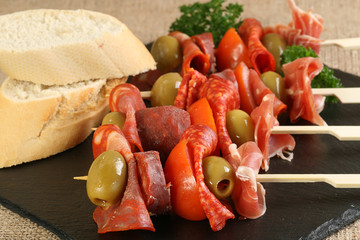 tapas meat olive and tomato