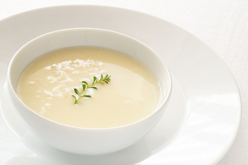 chicken soup with lemon, egg, and rice decorated with thyme