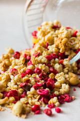 Plate of homemade muesli with cornflakes, freezedried cranberry, cashew, candied fruit, raisins.