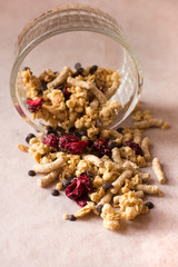 Plate of homemade muesli with cornflakes, bran, chocolate drops, freezedried cherry.