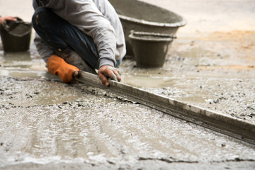 labor plastering cement with trowel for build new floor for renovation house