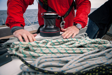 Hands sailor braid rigging ropes on a yacht