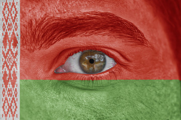 Human face and eye painted with flag of Belarus