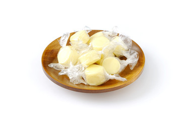 Candy cheese, cheese made similar to candy on wooden plate isolated and white background.