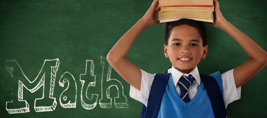 Composite image of smiling schoolboy carrying books on head over