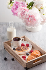 Fototapeta na wymiar Romantic breakfast with coffee, croissant, chocolate cookies and berries