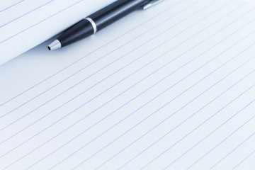 Black writing pen on paper background