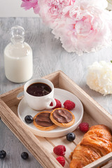 Fototapeta na wymiar Romantic breakfast with coffee, croissant, chocolate cookies and berries