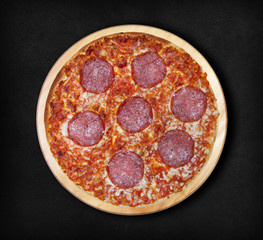 Pizza salami on a black background. Visit my page. You will be able to find an image for every pizza sold in your cafe or restaurant.