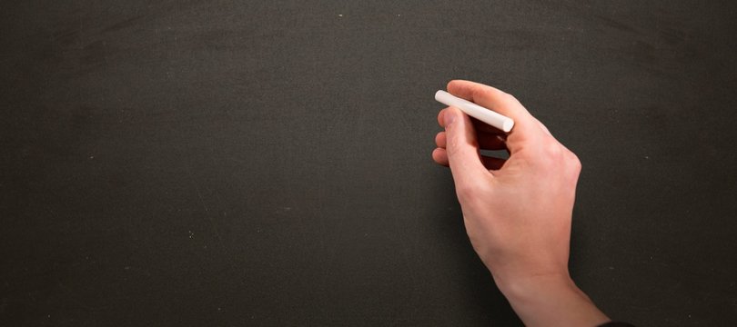 Composite image of man drawing on chalkboard