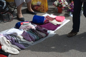 An old lady sells hand-knit socks on the street