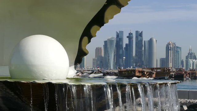 Close up from the Pearl Monument and fountain located along the Dhow Harbour with the Doha skyline in the background