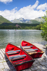 Panorama mountain lake Strbske Pleso in the Tatra mountains. Summers colors and boat for swimming
