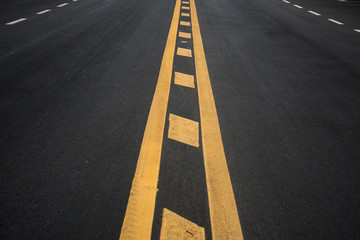 Yellow stripes on asphalt road