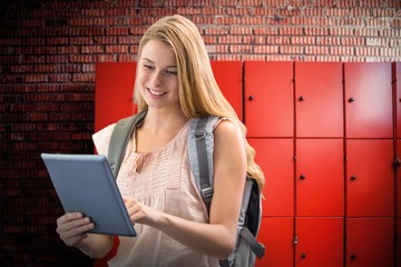 Composite image of happy student using tablet